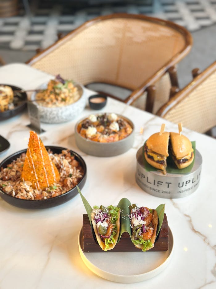A selection of gourmet dishes elegantly presented on a marble table in a modern restaurant setting.